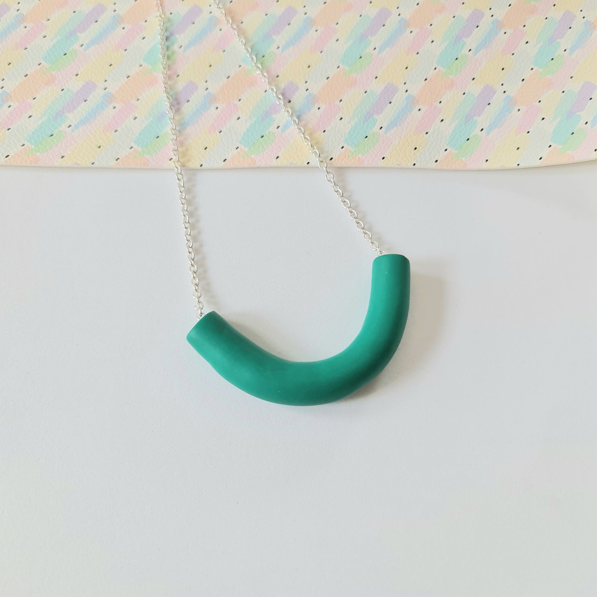 A chunky green necklace handmade from polymer clay. It is on a white background.