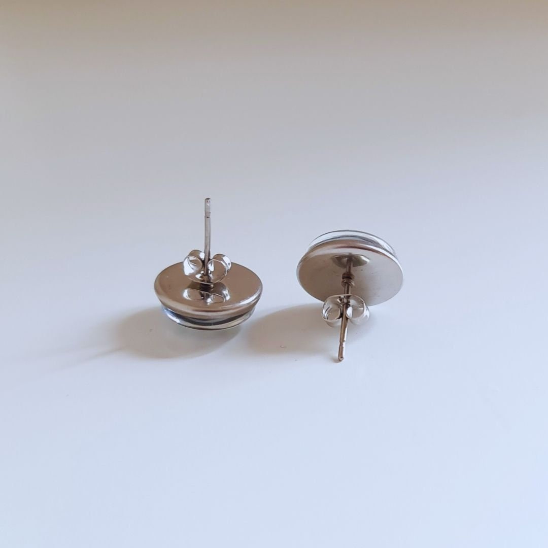 The back of a pair of stud earrings. The picture shows the stainless steel earring posts with butterfly backs.